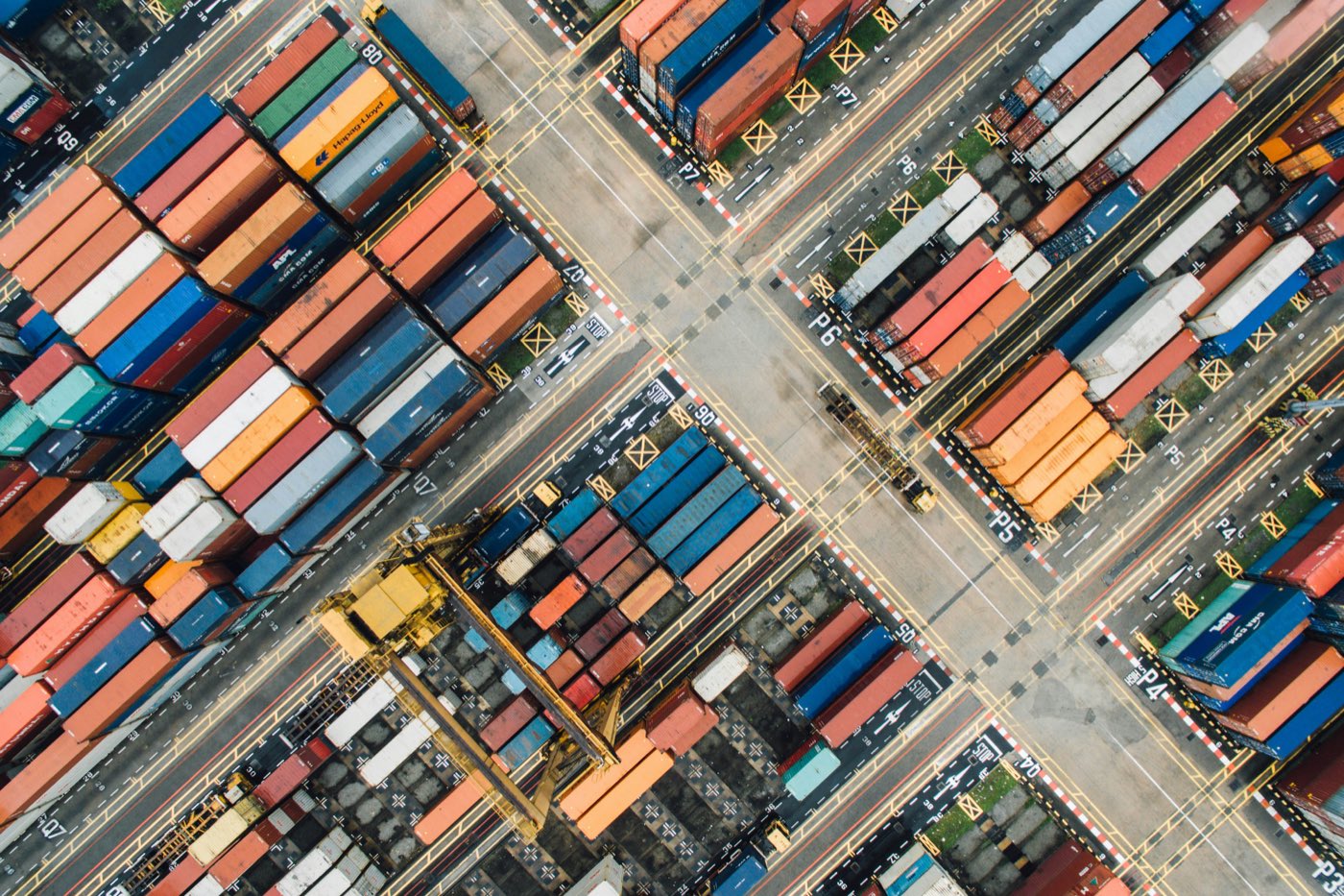 Aerial view of stacked shipping containers at a port terminal